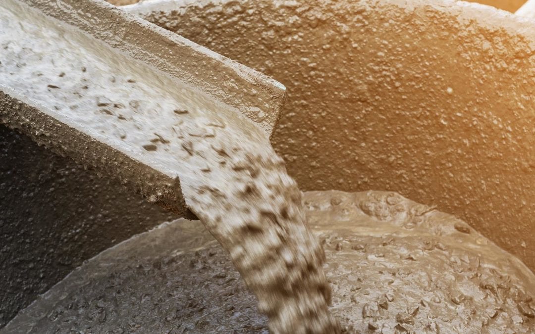 Close-up imagery of cement being poured.
